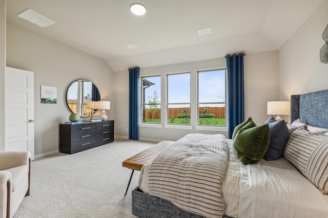 carpeted bedroom featuring lofted ceiling