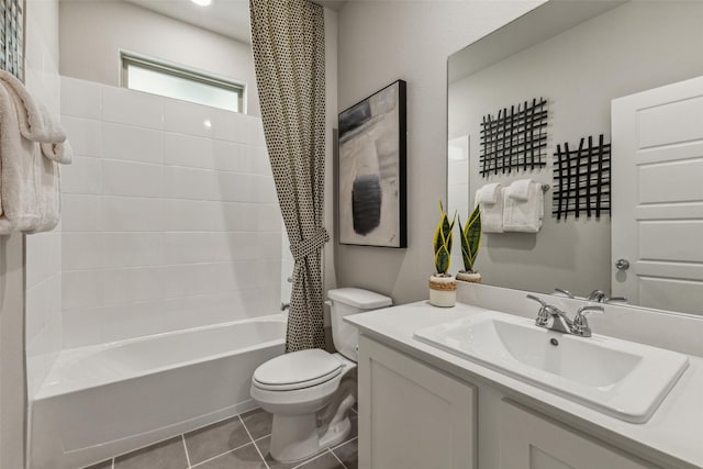 full bathroom featuring vanity, toilet, tile patterned flooring, and shower / tub combo