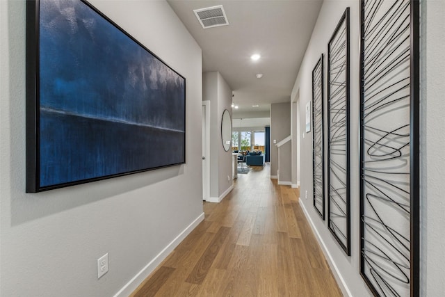 hall with hardwood / wood-style flooring