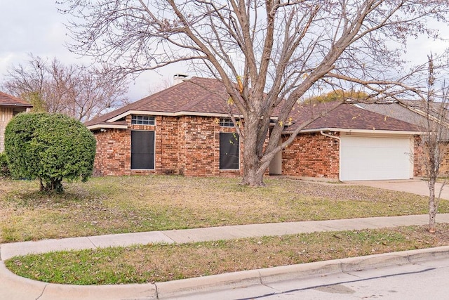 view of front of home with a garage and a front lawn