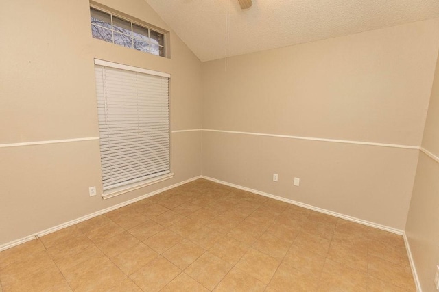 spare room featuring vaulted ceiling and a textured ceiling