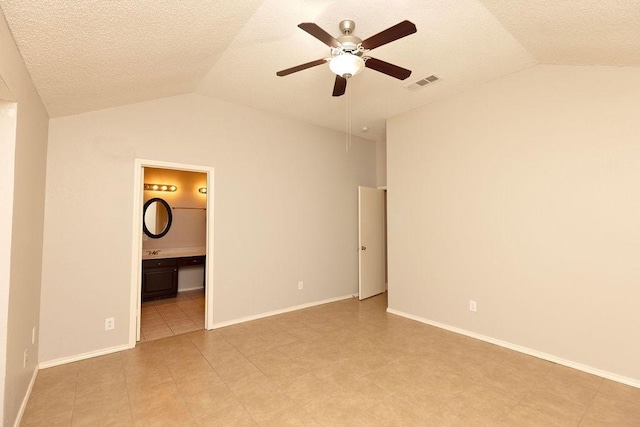 empty room featuring lofted ceiling, a textured ceiling, and ceiling fan