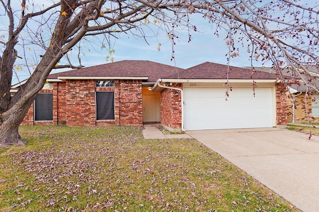 ranch-style home with a garage and a front yard