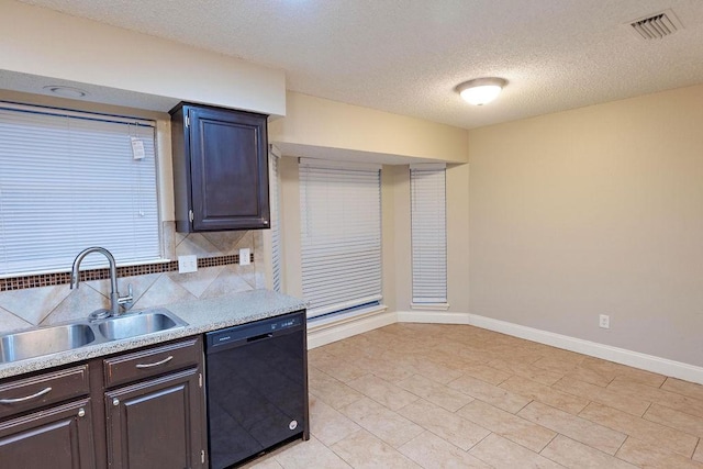 kitchen featuring dishwasher, sink, decorative backsplash, dark brown cabinets, and a textured ceiling