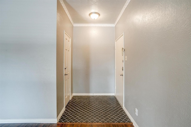 corridor with hardwood / wood-style flooring and ornamental molding