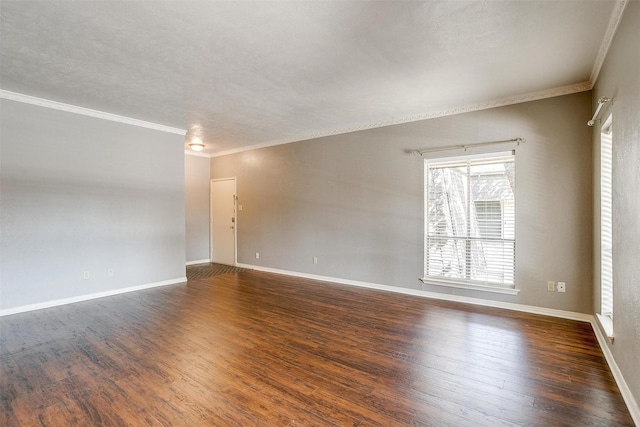 spare room featuring crown molding and dark hardwood / wood-style floors