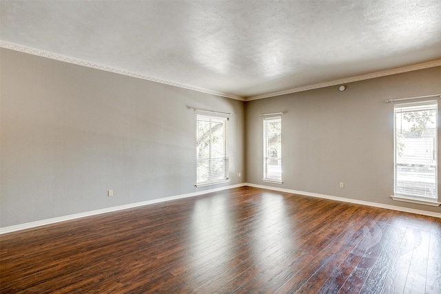 spare room featuring crown molding, a textured ceiling, and dark hardwood / wood-style flooring