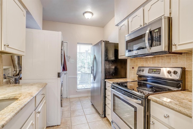 kitchen featuring white cabinetry, light tile patterned floors, plenty of natural light, and stainless steel appliances