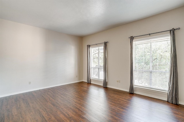 spare room with dark hardwood / wood-style flooring