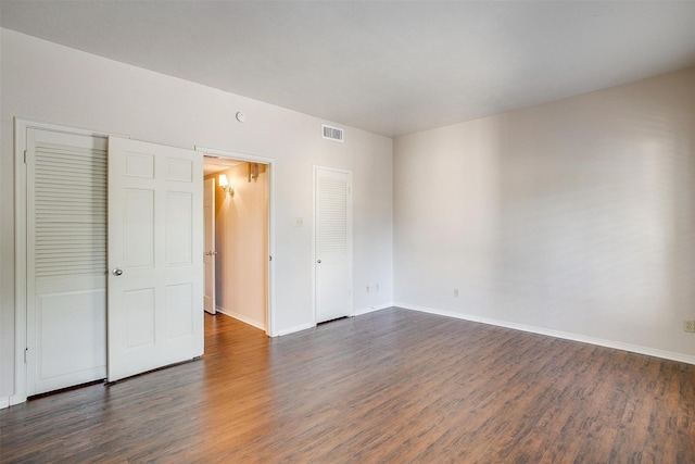 spare room with dark hardwood / wood-style flooring