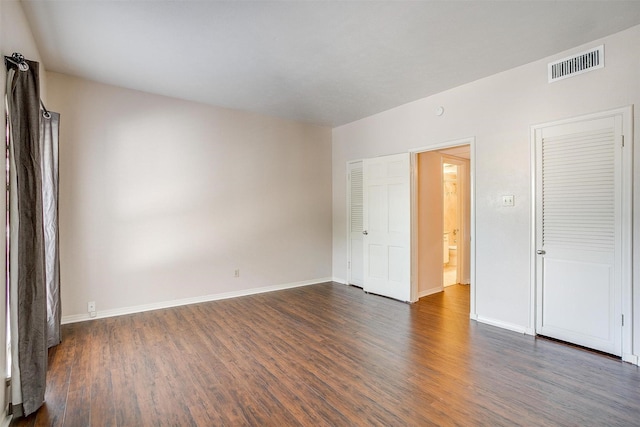 unfurnished bedroom featuring dark wood-type flooring