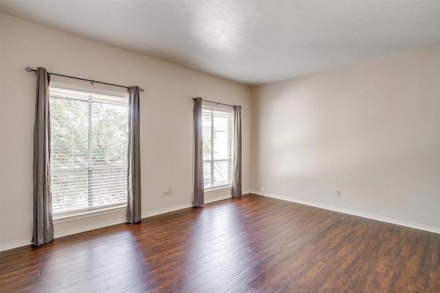 spare room with dark wood-type flooring