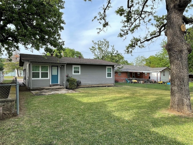 rear view of house with a lawn