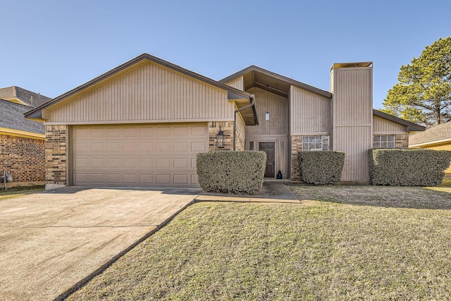 view of front of home with a garage and a front yard