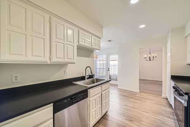 kitchen featuring sink, light hardwood / wood-style floors, a chandelier, and appliances with stainless steel finishes