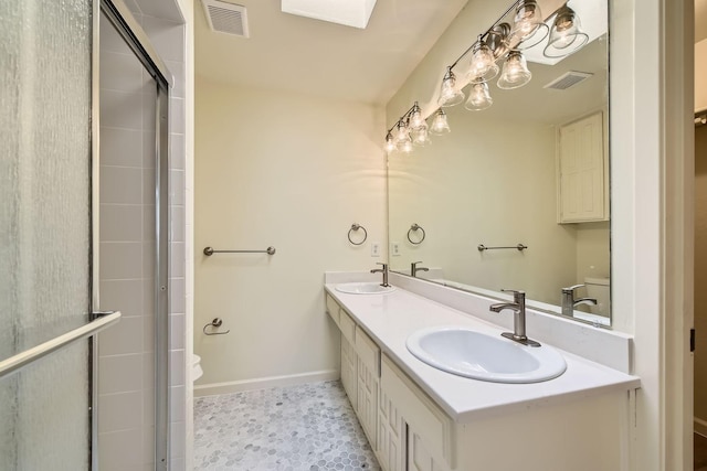 bathroom featuring vanity, tile patterned floors, and walk in shower