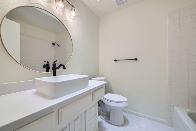 full bathroom with vanity, tiled shower / bath, and toilet