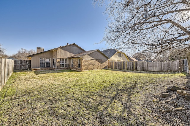 rear view of property featuring a yard