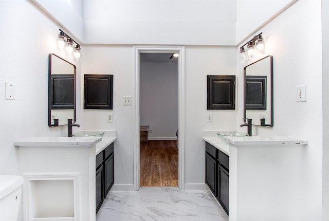 bathroom featuring vanity and toilet