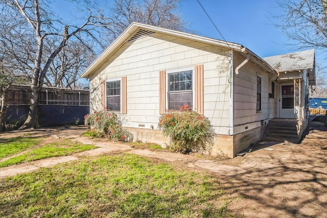 view of side of home featuring a yard