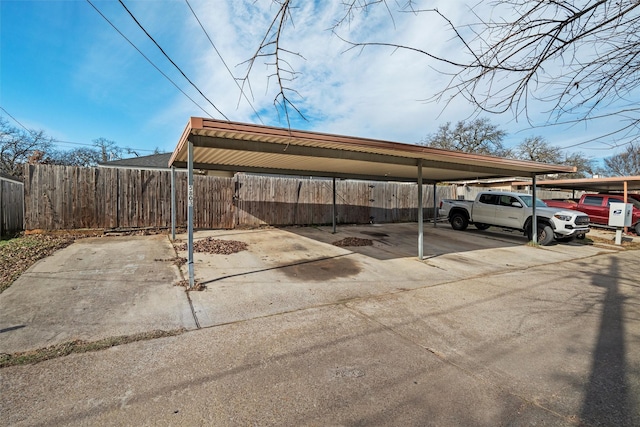 view of parking / parking lot featuring a carport