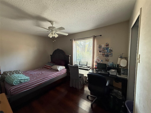 bedroom featuring ceiling fan, a textured ceiling, and wood finished floors