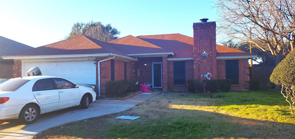 single story home with a garage and a front lawn