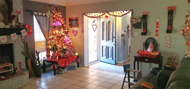 tiled foyer entrance with a fireplace