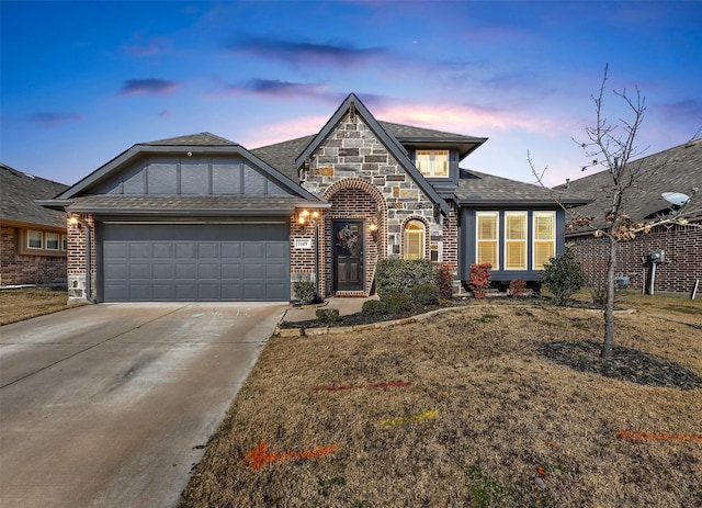 view of front of home featuring a garage and a lawn