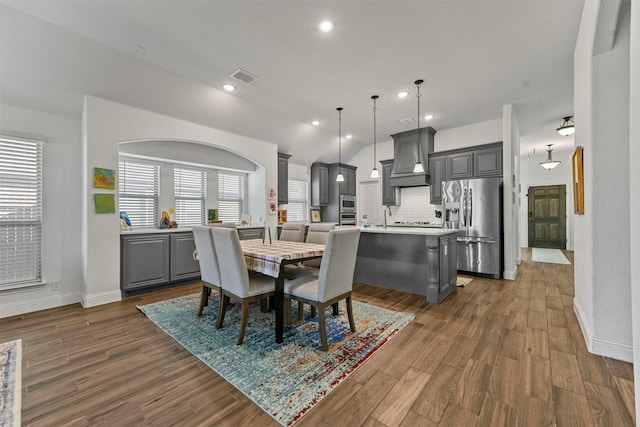 dining space featuring dark hardwood / wood-style flooring and a healthy amount of sunlight