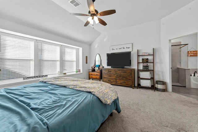 bedroom with vaulted ceiling, carpet floors, ceiling fan, and ensuite bath