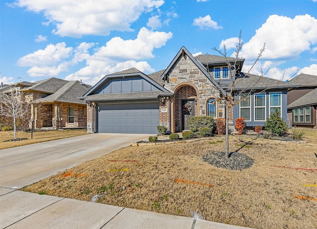 view of front of property featuring a garage and a front lawn