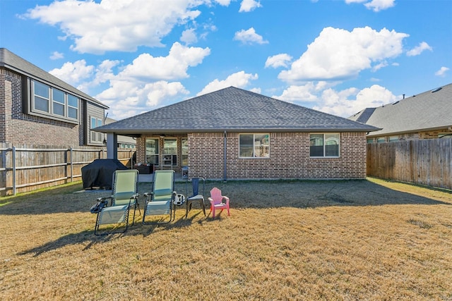 rear view of property featuring a lawn