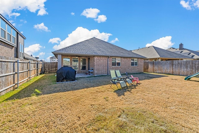 back of property featuring a yard and a patio