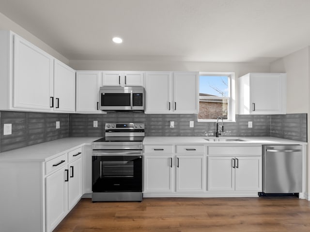 kitchen with white cabinetry, appliances with stainless steel finishes, and sink