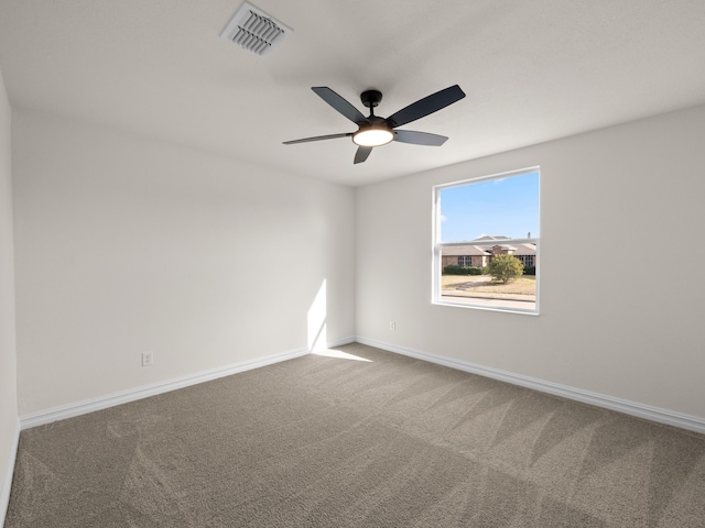 carpeted spare room with ceiling fan