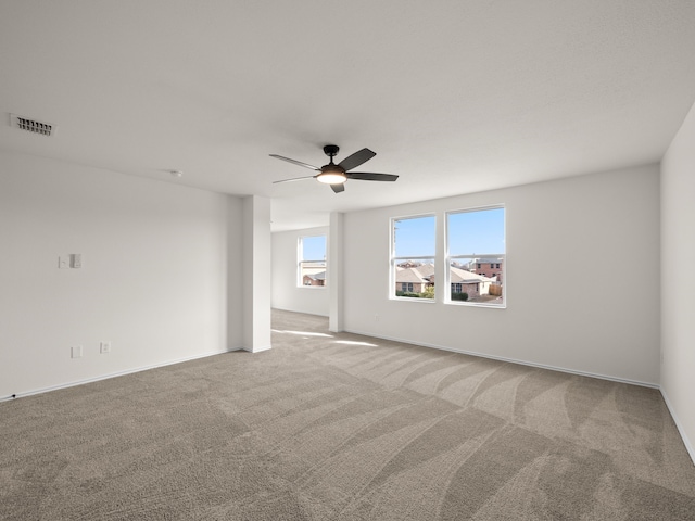 carpeted spare room featuring ceiling fan