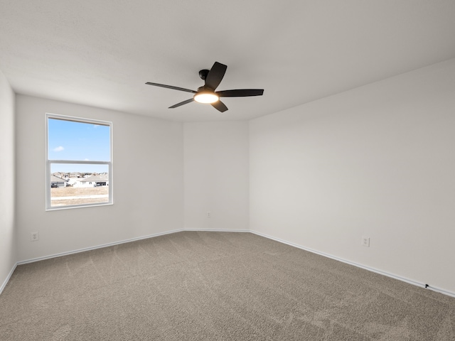 spare room featuring carpet and ceiling fan