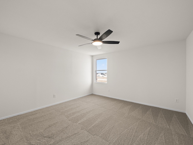 empty room featuring light carpet and ceiling fan