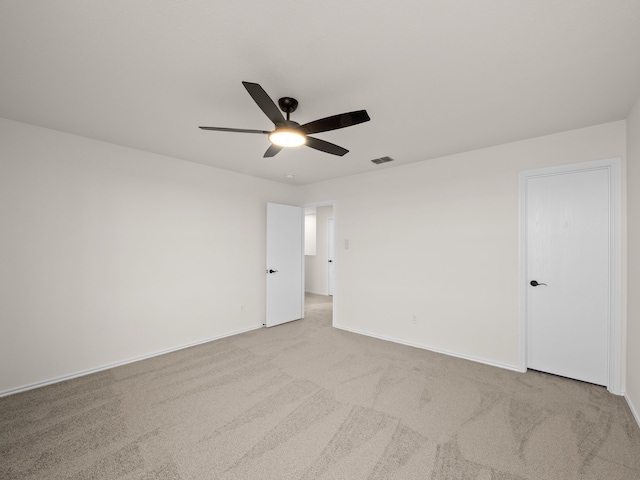 unfurnished room featuring ceiling fan and light colored carpet