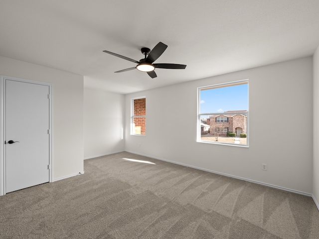 carpeted empty room with ceiling fan