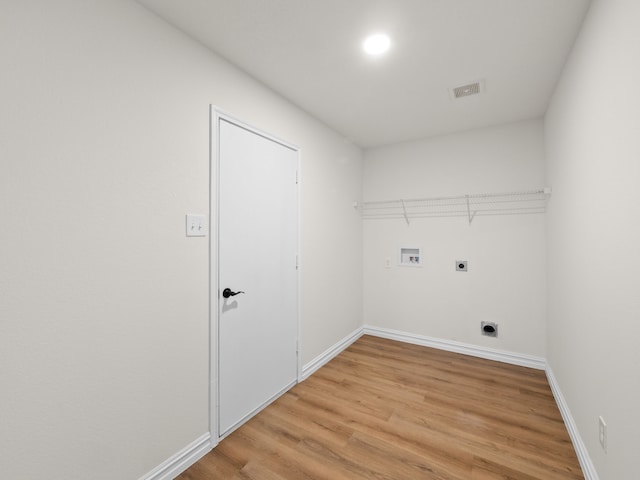 washroom featuring electric dryer hookup, washer hookup, and light hardwood / wood-style floors