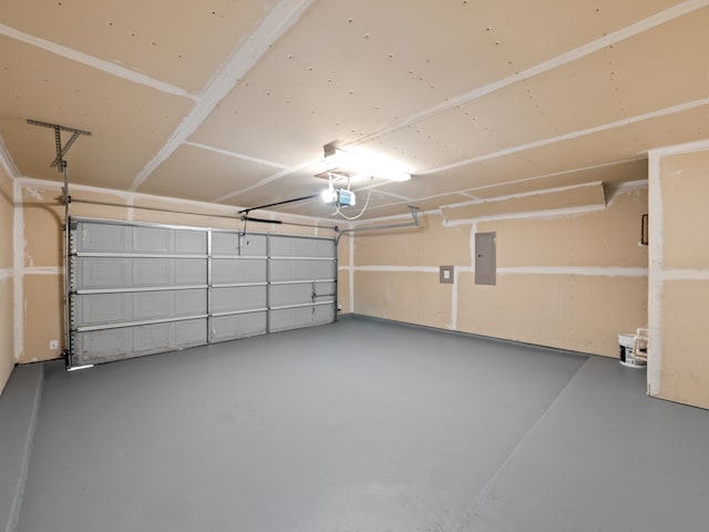 garage with a garage door opener and electric panel