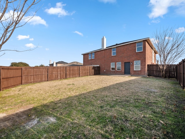 rear view of property featuring a yard