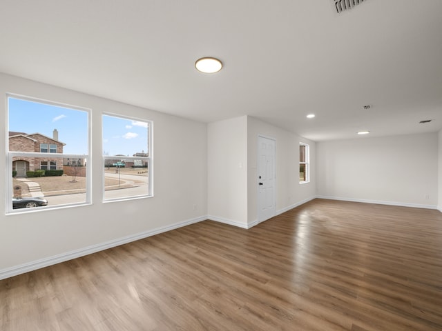 unfurnished room with hardwood / wood-style flooring