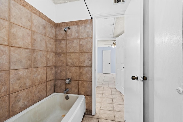 bathroom featuring ceiling fan, tiled shower / bath combo, and tile patterned flooring