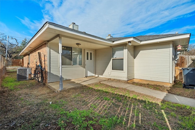 rear view of house with cooling unit