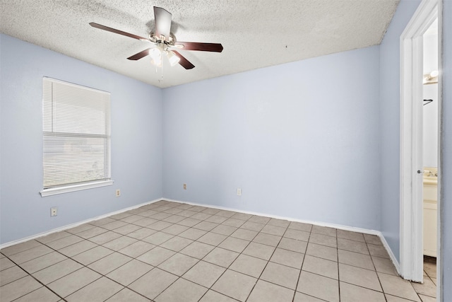 unfurnished room with light tile patterned floors, a textured ceiling, and ceiling fan