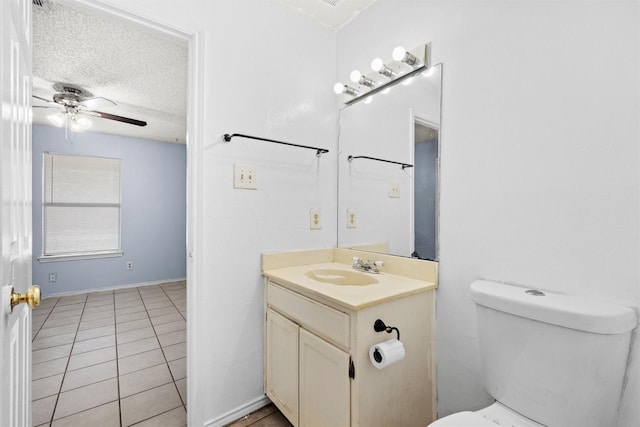 bathroom featuring toilet, a textured ceiling, vanity, ceiling fan, and tile patterned flooring