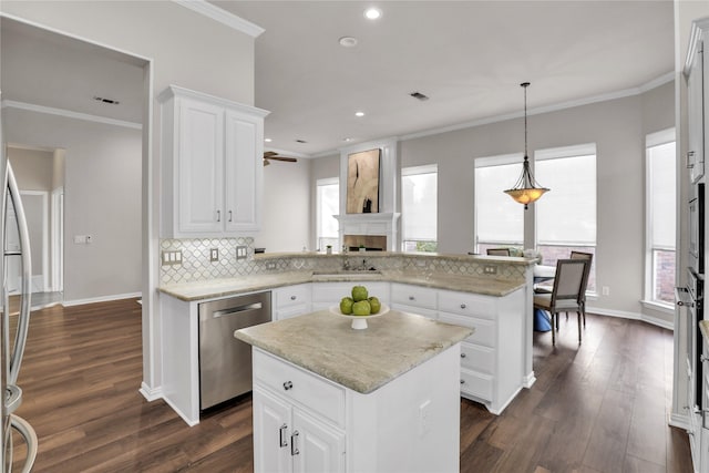 kitchen with white cabinetry, stainless steel dishwasher, kitchen peninsula, and a kitchen island